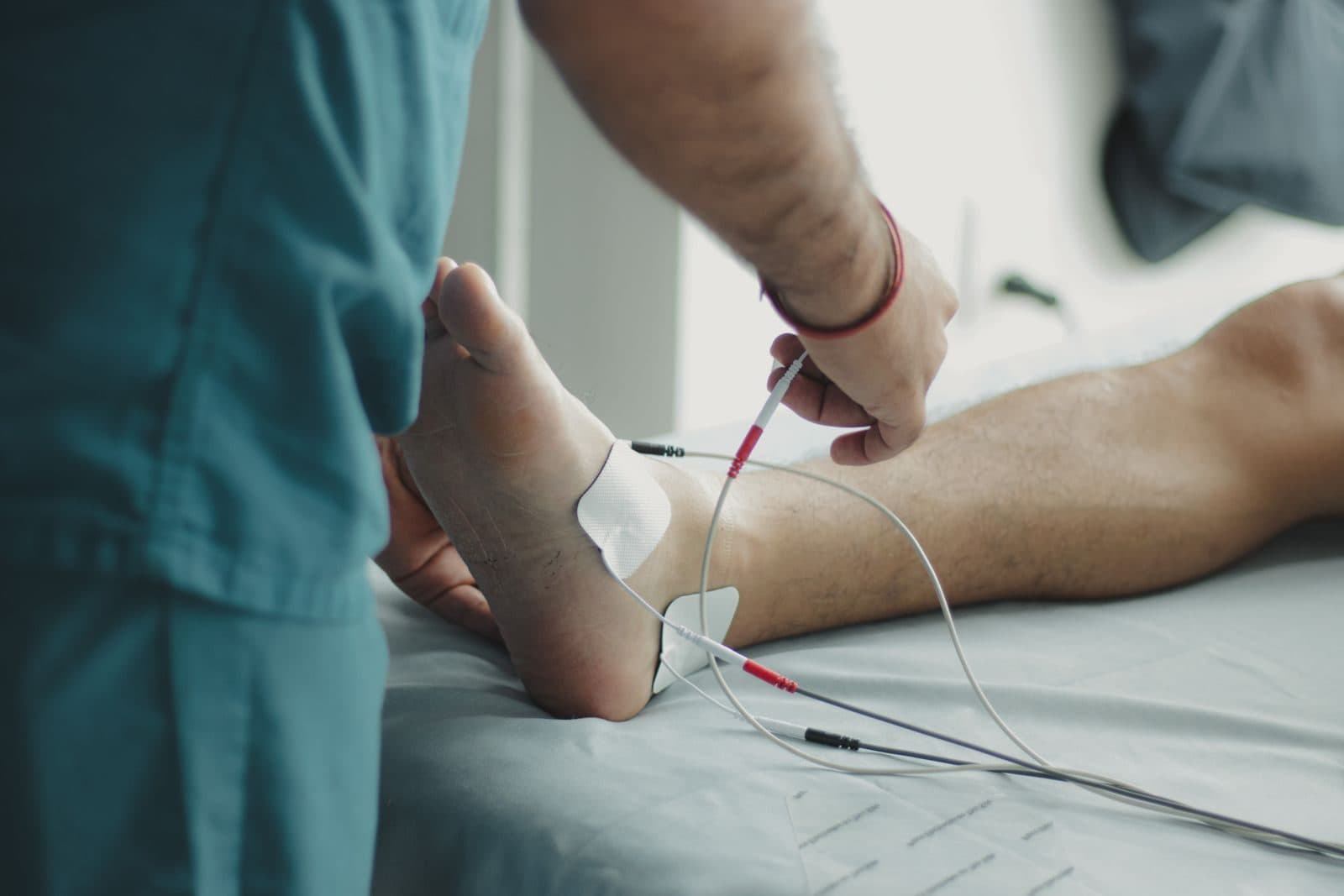Clinician examining a patient's foot for neuropathy symptoms